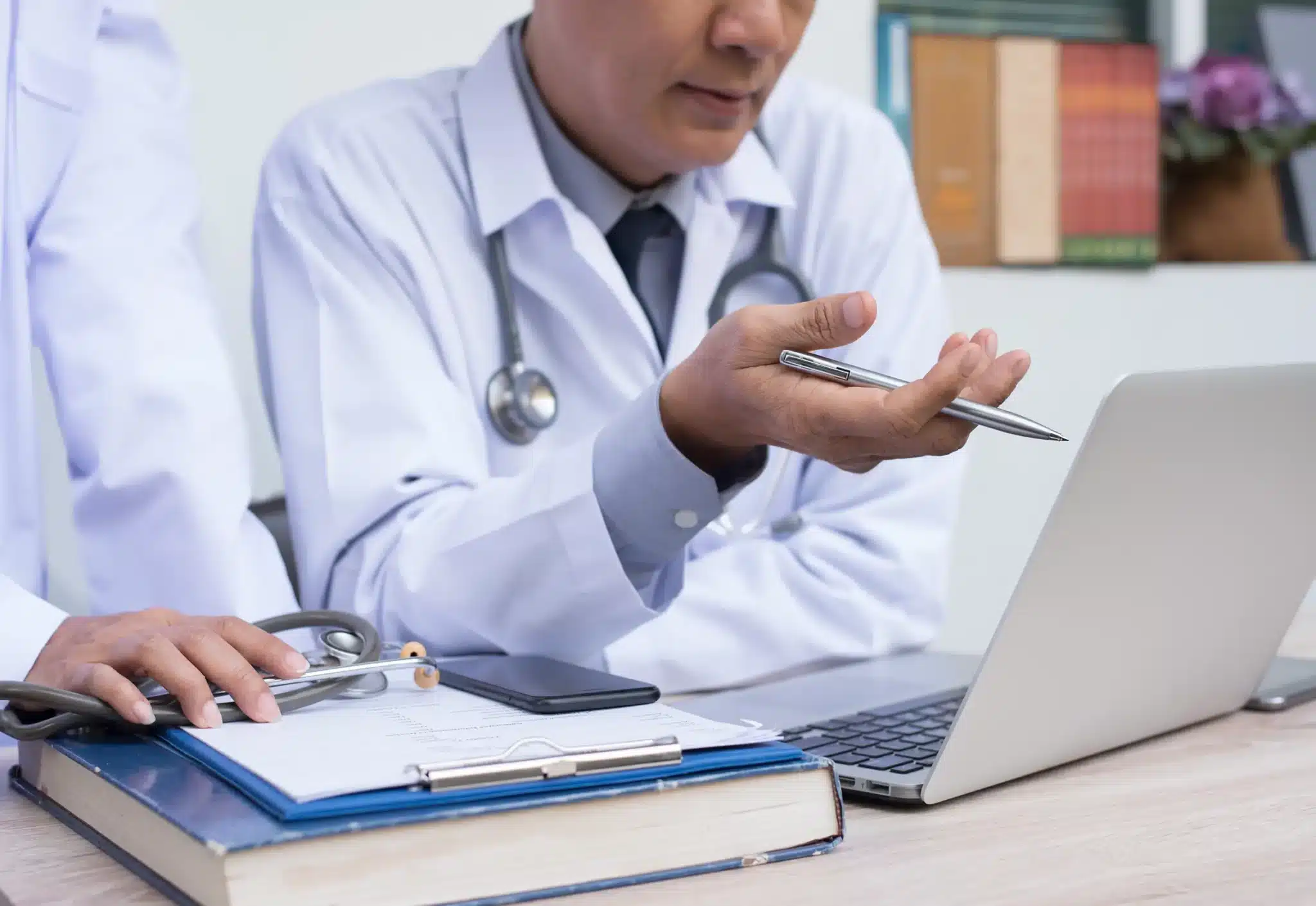 doctors work on a Medicare appeal together at laptop
