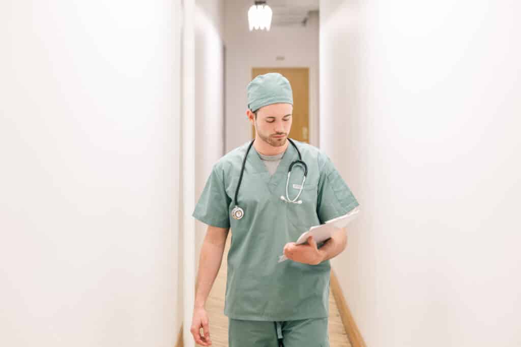 Doctor walking down hallwya with clipboard